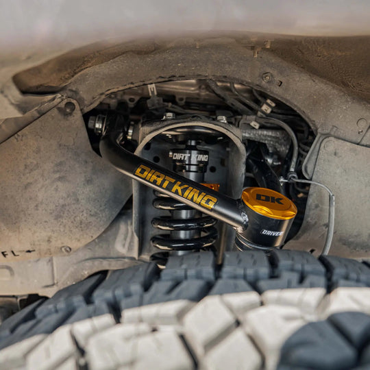Dirt King MT Trail Runner Kit coilover for Toyota - gold anodized top, black shock body in wheel well.