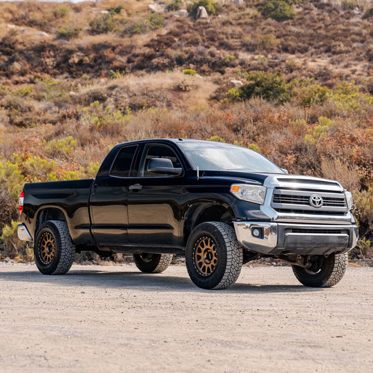 Dirt King MT PreRunner Kit Toyota pickup on black truck with gold beadlock wheels