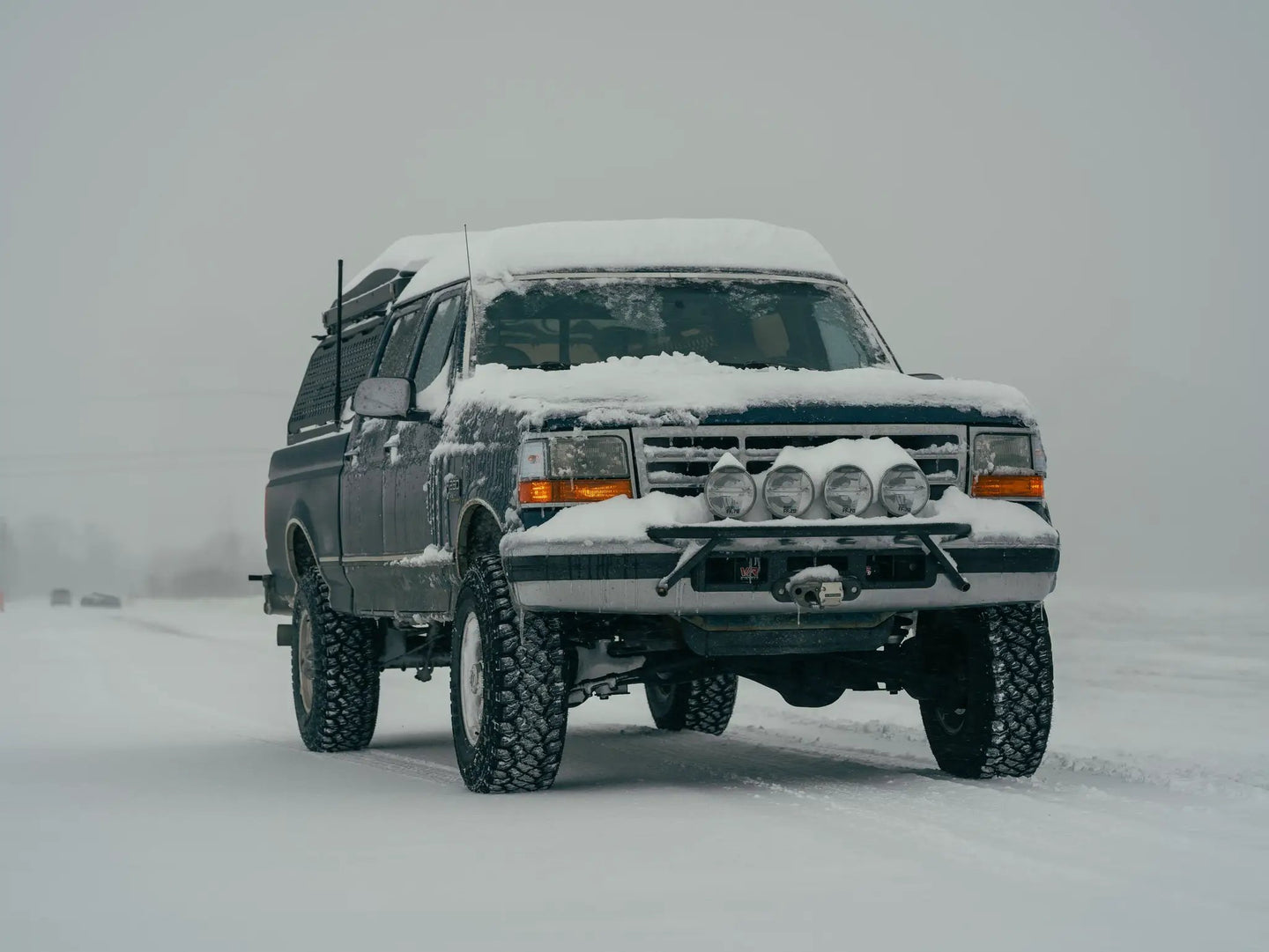 JC Customs OBS Ford Hidden Winch Mount bumper with five round lights, snow-covered front.