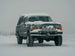 JC Customs OBS Ford Hidden Winch Mount bumper with five round lights, snow-covered front.