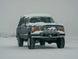JC Customs OBS Ford Hidden Winch Mount bumper with five round lights, snow-covered front.