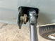 OBS Ford 80-97 Gas Cap Holder JC Customs, black cap in gray housing with warning label