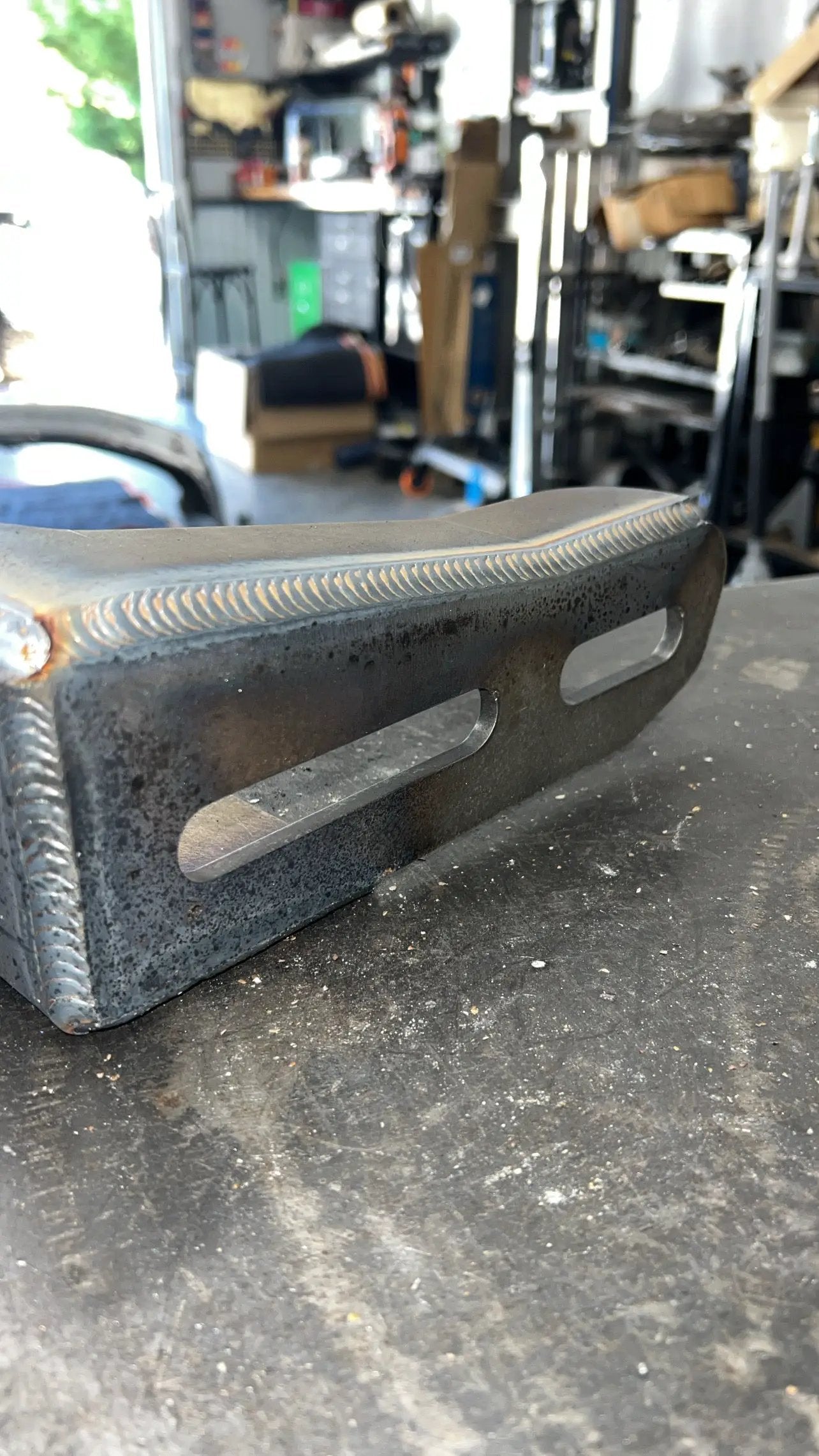 JC Customs OBS Ford Hidden Winch Mount - steel bracket with weld beads, side profile, dual oblong mounting slots