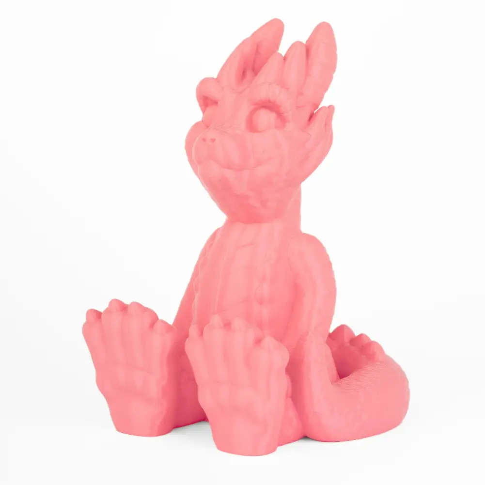 Pink PLA+ 3D-printed dragon figurine with curled tail and raised paws