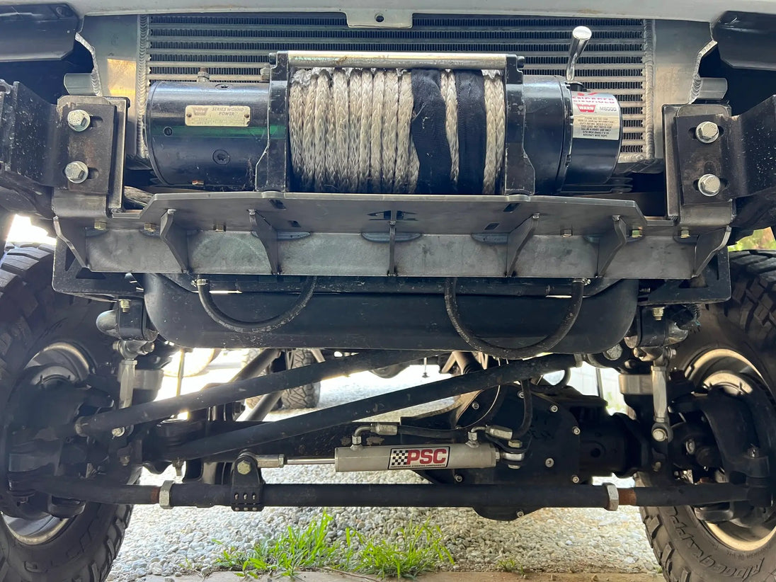OBS Ford Hidden Winch Mount JC Customs — winch drum with steel cable mounted behind bumper.