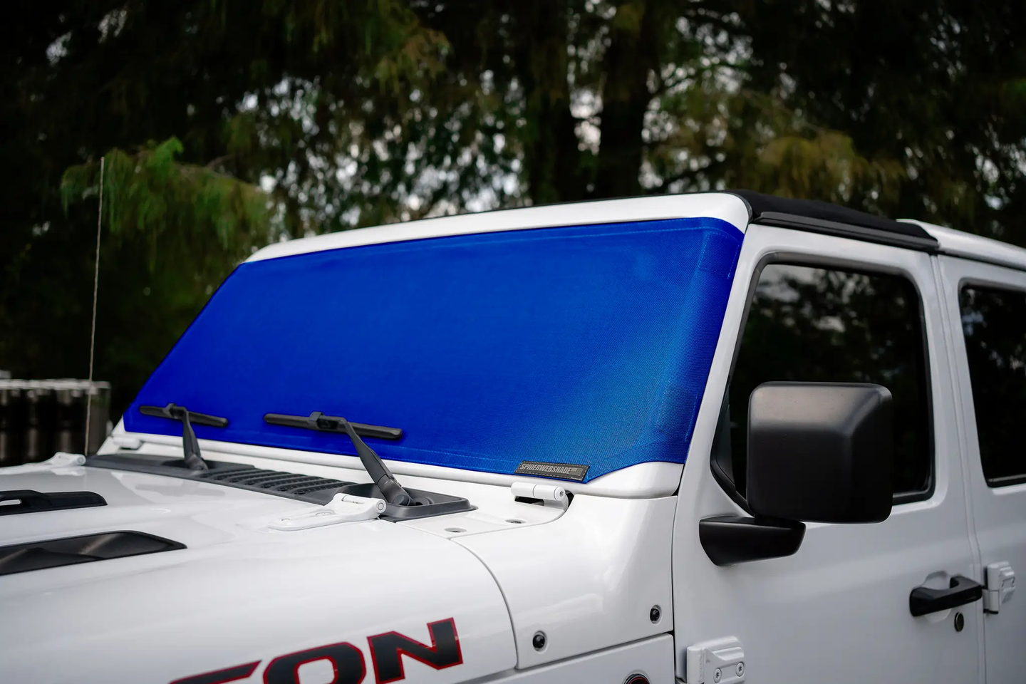 Solar shade for Jeep Wrangler/Gladiator in blue by SpiderWebShade, installed on the windshield.