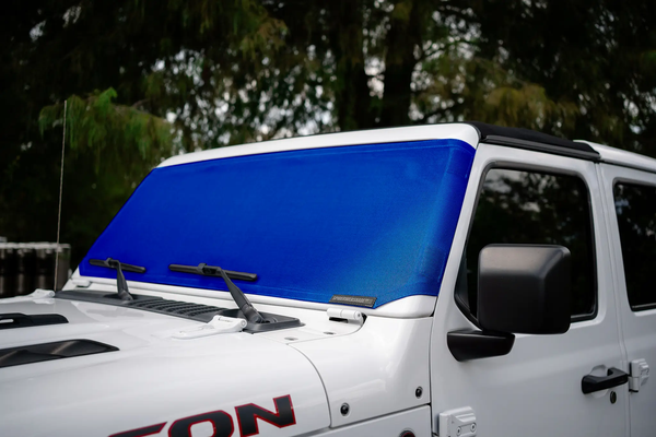 Solar shade for Jeep Wrangler/Gladiator in blue by SpiderWebShade, installed on the windshield.