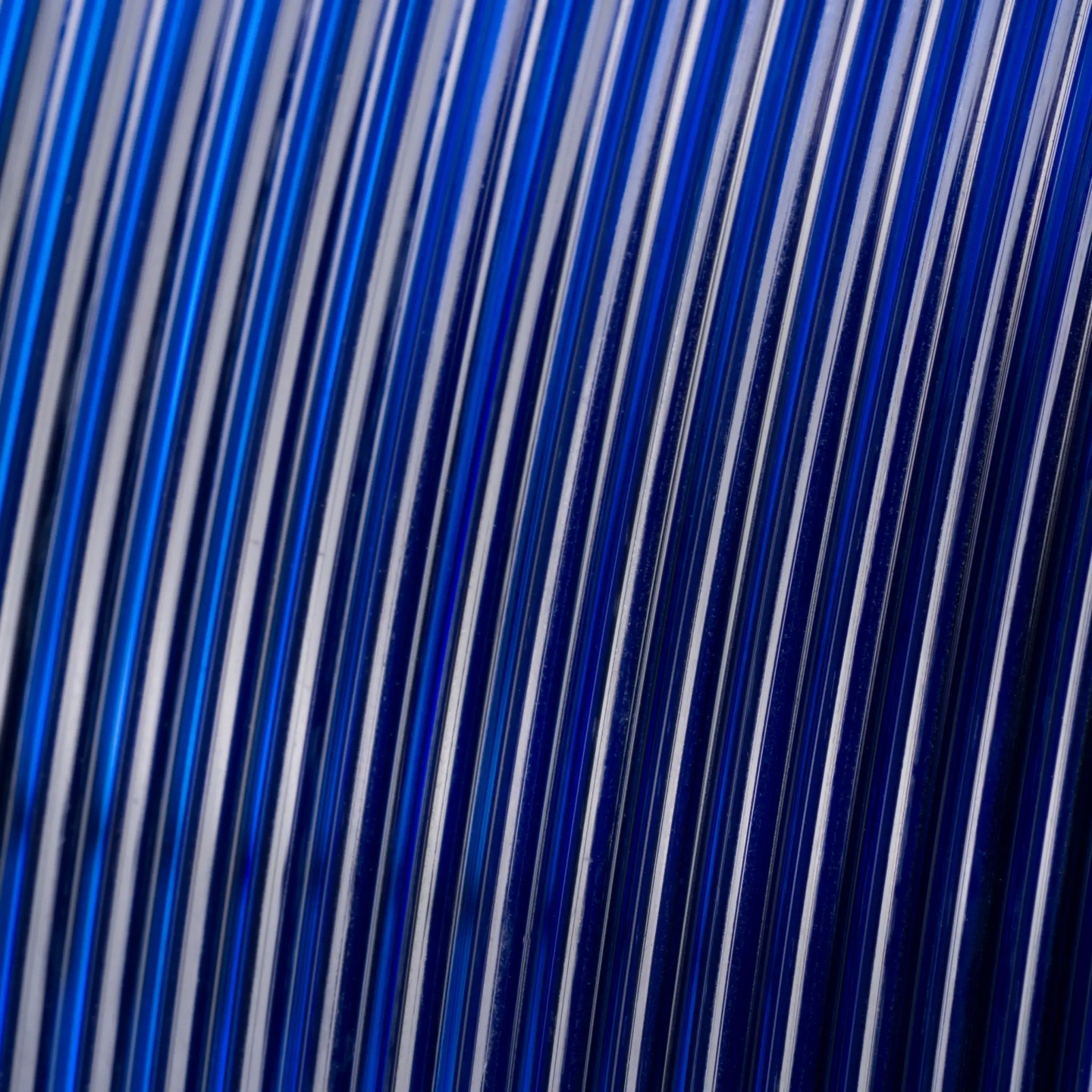 PETG Translucent filament for 3D printers, blue, close-up of translucent strands