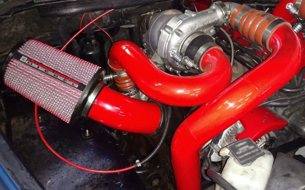 Power Driven Ultimate Towing Compounds Interstage Pipe red tubes with clamps, Power Driven Diesel air filter visible