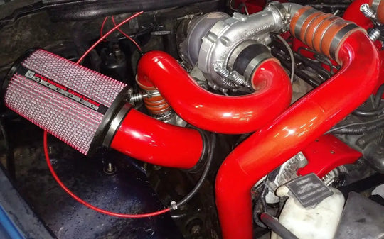 Power Driven Ultimate Towing Compounds Interstage Pipe red tubes with clamps, Power Driven Diesel air filter visible