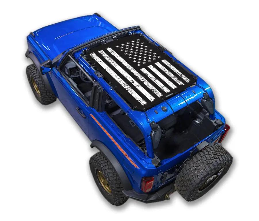 Sun shade top for Ford Bronco (2021–2026) by SpiderWebShade; blue vehicle with white flag print