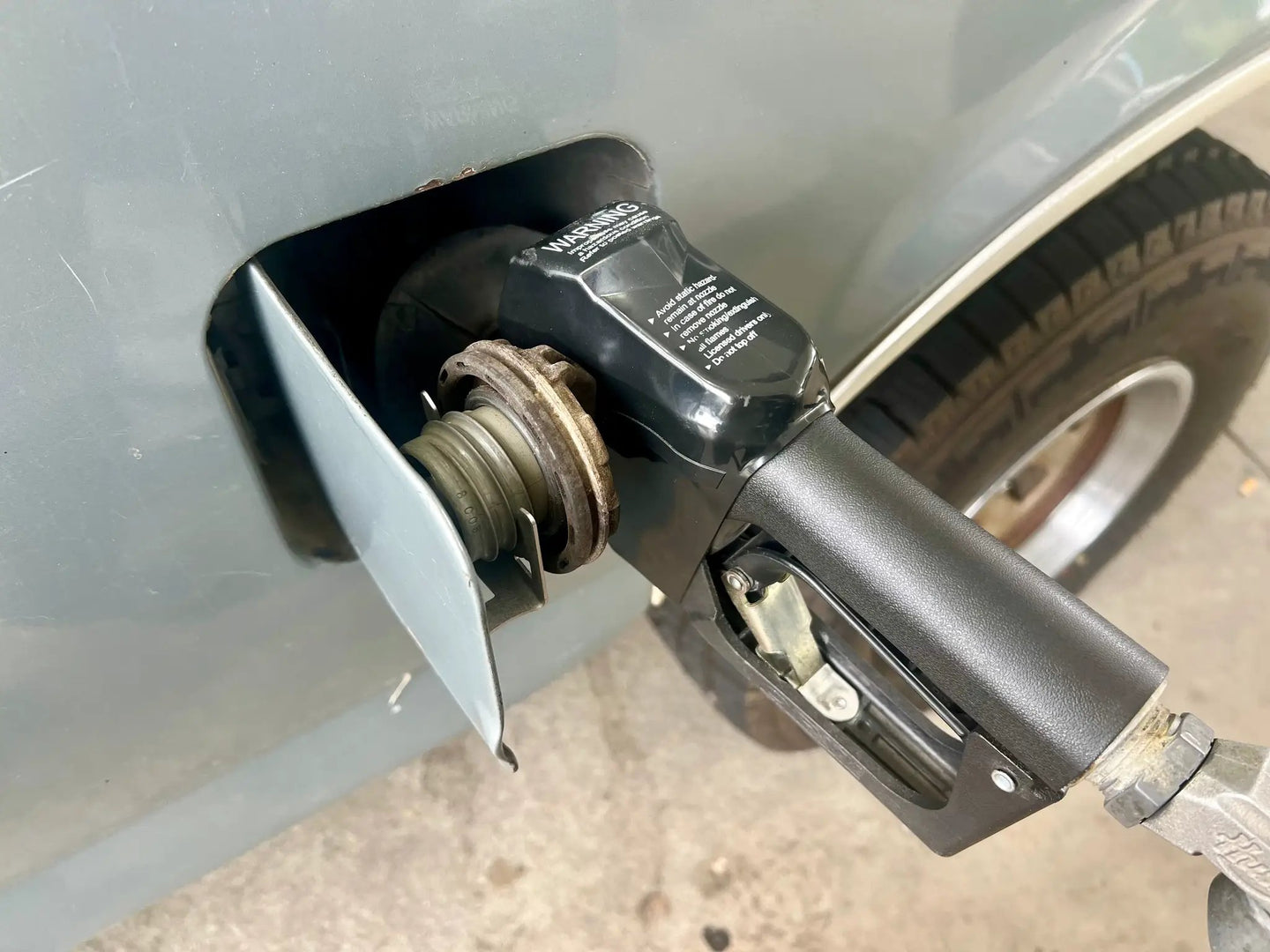 Gas Cap Holder JC Customs OBS Ford 1980-1997, black plastic mounting near fuel filler neck
