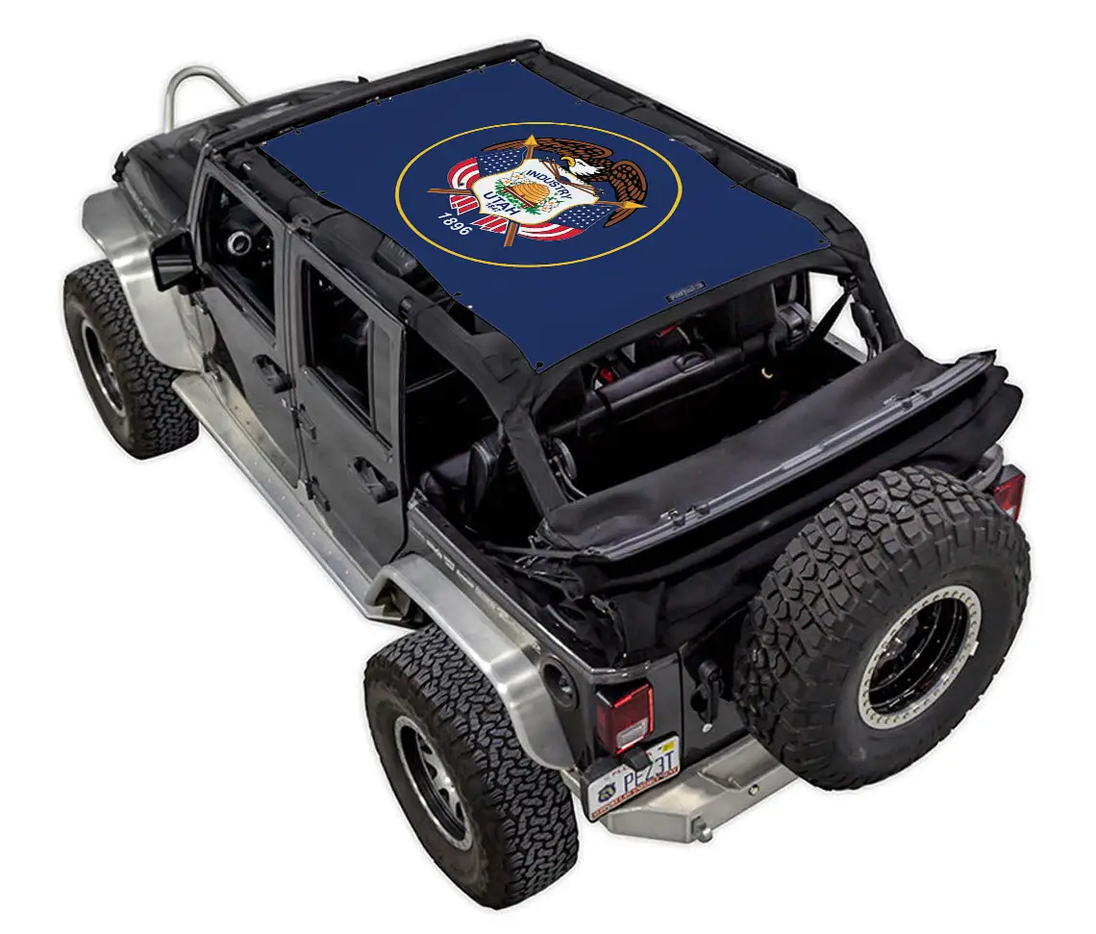 Sun shade top for Jeep Wrangler JKU 4-Door by SpiderWebShade, stock printed blue shade with circular emblem.