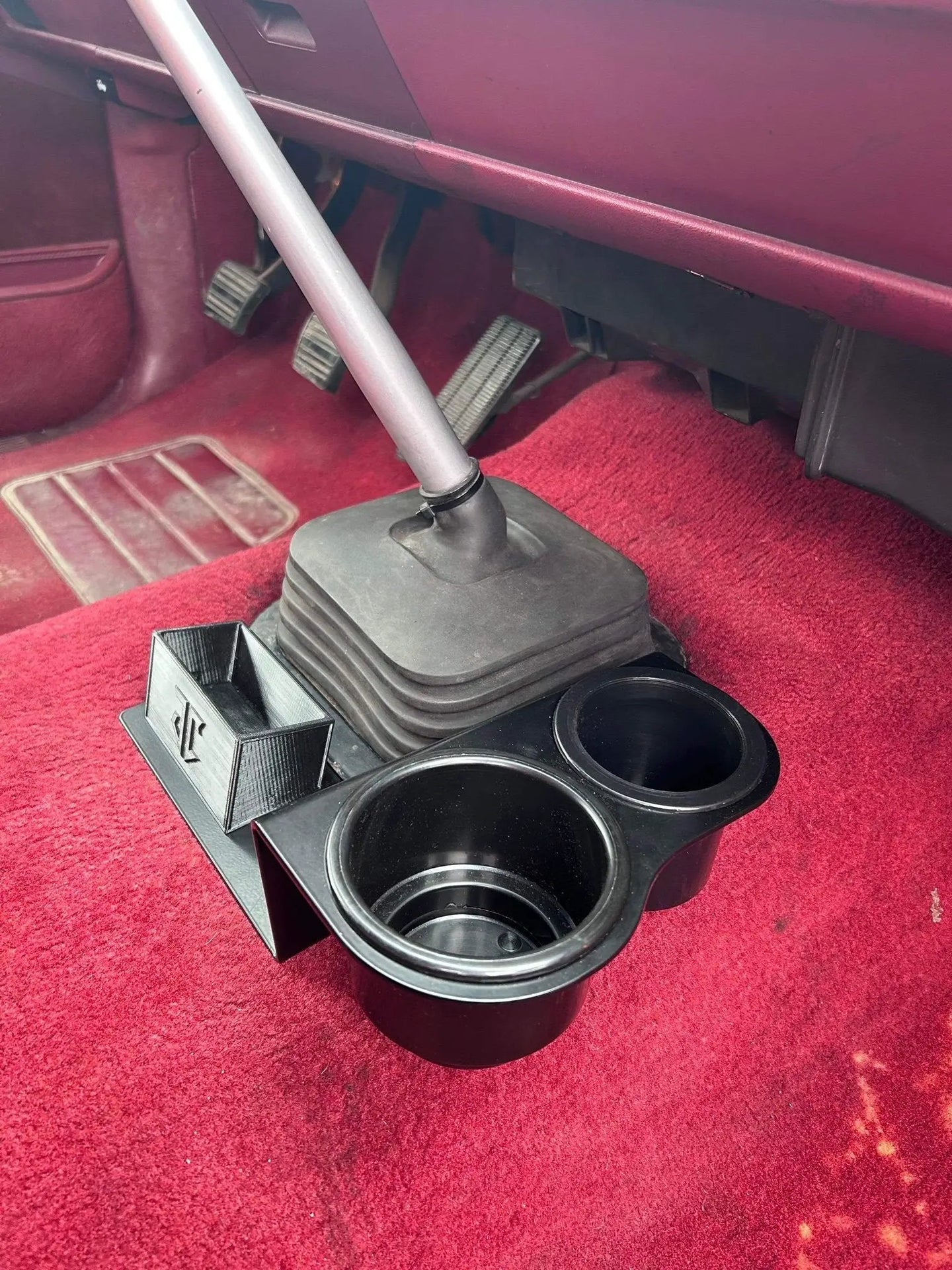 OBS Chevy C/K Series shifter-mounted cup holder JC Customs with dual cup openings in red interior