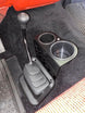Ford F-Series Auto Shifter-Mounted Cup Holder JC Customs, black plastic center console with dual cup openings