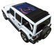 Sun shade top by SpiderWebShade for Jeep Wrangler JLU, blue North Dakota flag print on white Jeep with folded black shade.