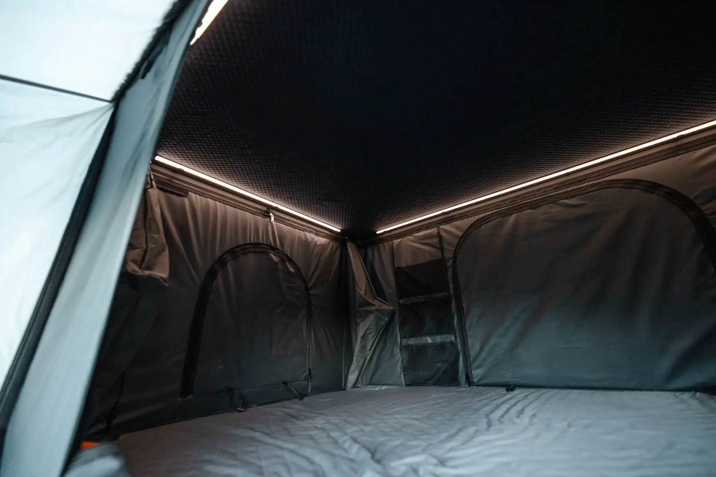 Aluminum Side-Opening Roof Top Tent by Smittybilt, interior with LED lighting and quilted mattress