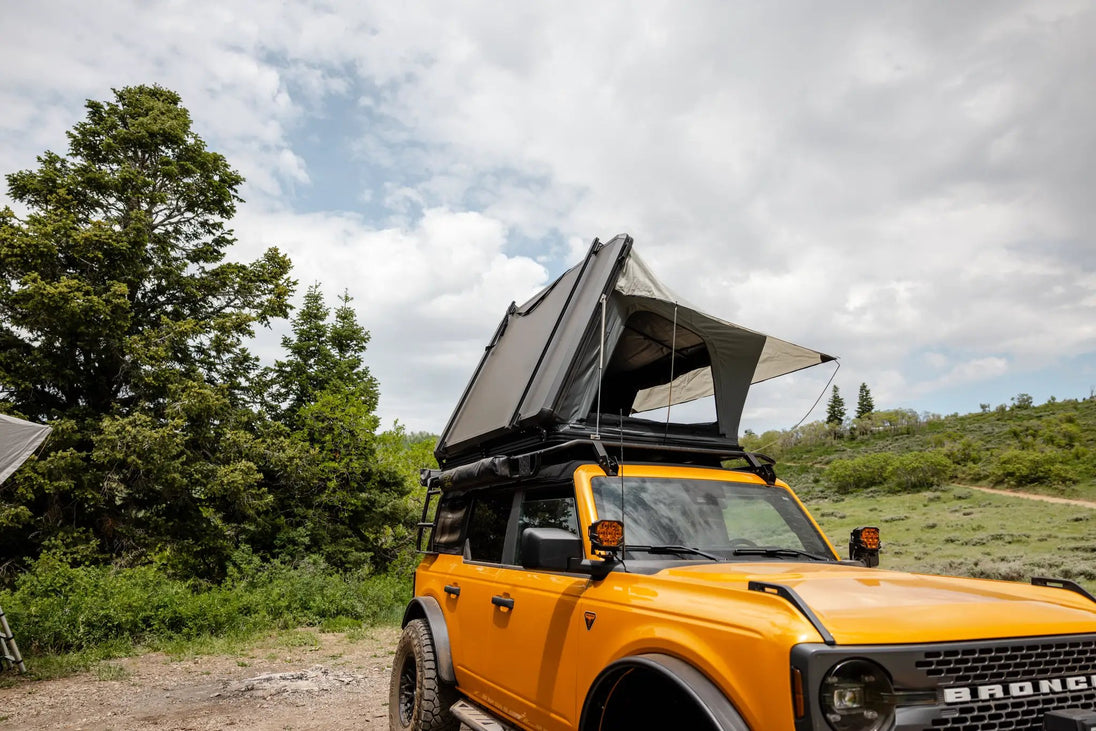 Aluminum PO Pup Roof Top Tent on orange Bronco with beige side-opening RTT