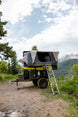 Overland X-L Hard Shell Tent on top of a rugged off-road rig with ladder, gray Smittybilt tent.