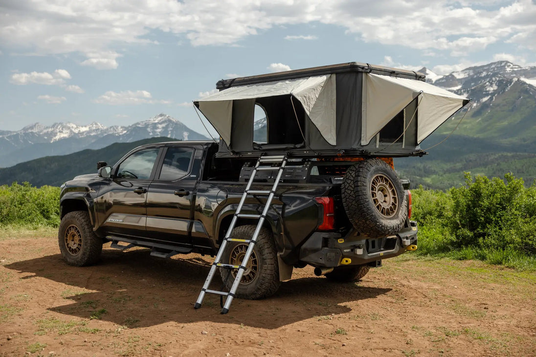 Aluminum side-opening roof top tent by Smittybilt on a pickup, beige canvas with ladder