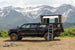 Aluminum Side Opening Roof Top Tent by Smittybilt on a black Toyota Tacoma with ladder