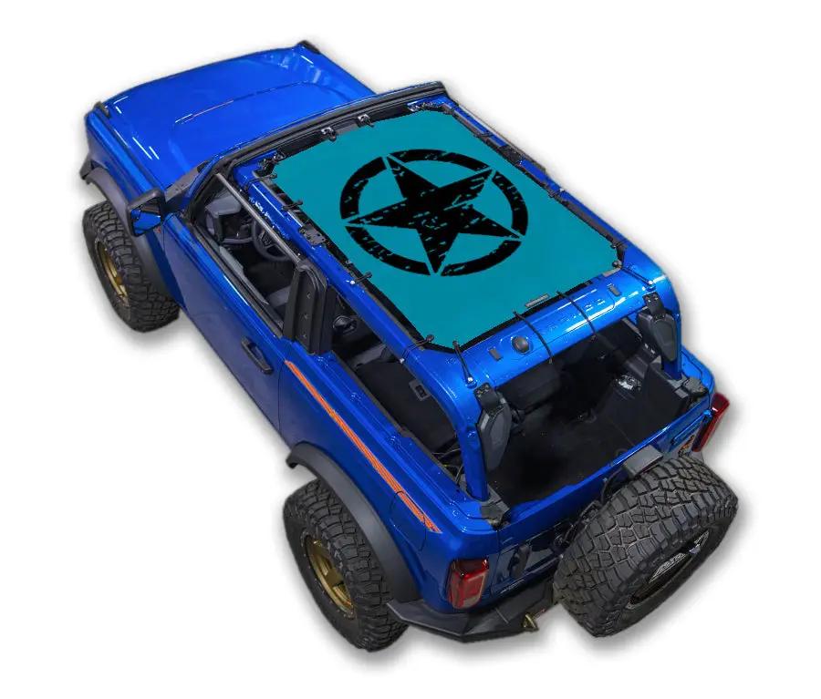 Sun Shade by SpiderWebShade for Ford Bronco (2021–2026); turquoise shade with black star logo on blue vehicle.