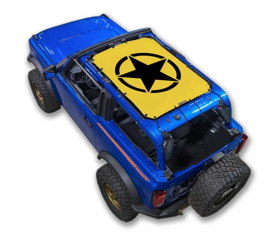 Sun Shade SPIDERWEBSHADE stock printed top for Ford Bronco (2021–2026); yellow top with black star logo on blue Bronco.