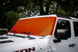 Solar shade for Jeep Wrangler/Gladiator by SPIDERWEBSHADE, orange mesh windshield shade on white Jeep