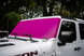 SpiderWebShade solar shade for Jeep Wrangler/Gladiator (2007-2026); bright pink windshield shade on a white Jeep