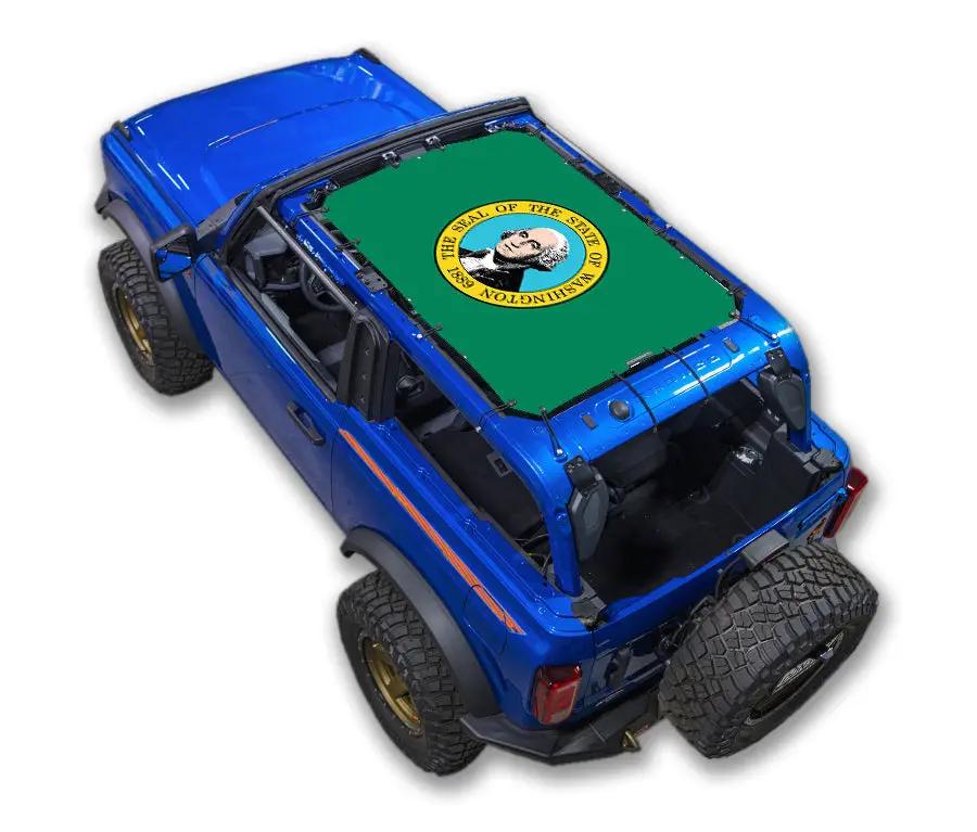 Sun Shade Ford Bronco (2021–2026) by SpiderWebShade; green stock-printed shade top with circular seal design.