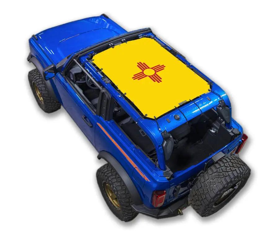 Sun shade top for Ford Bronco by SpiderWebShade, yellow printed with red Zia sun symbol