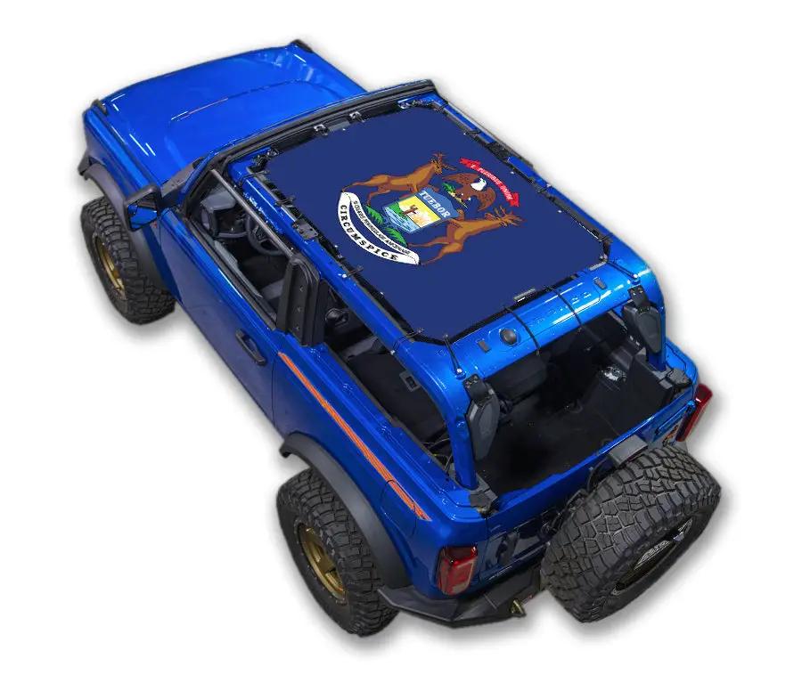 Sun shade top for Ford Bronco (2021–2026) by SPIDERWEBSHADE, blue vehicle with printed crest on shade