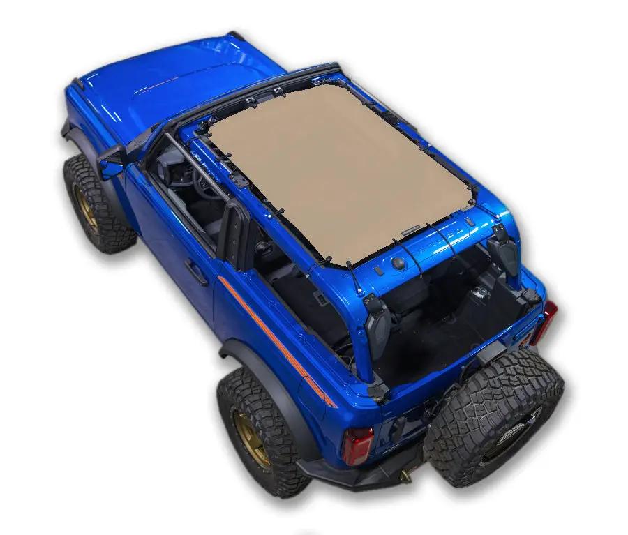 Ford Bronco sun shade top by SpiderWebShade; beige stock printed shade on blue SUV, 2021–2026