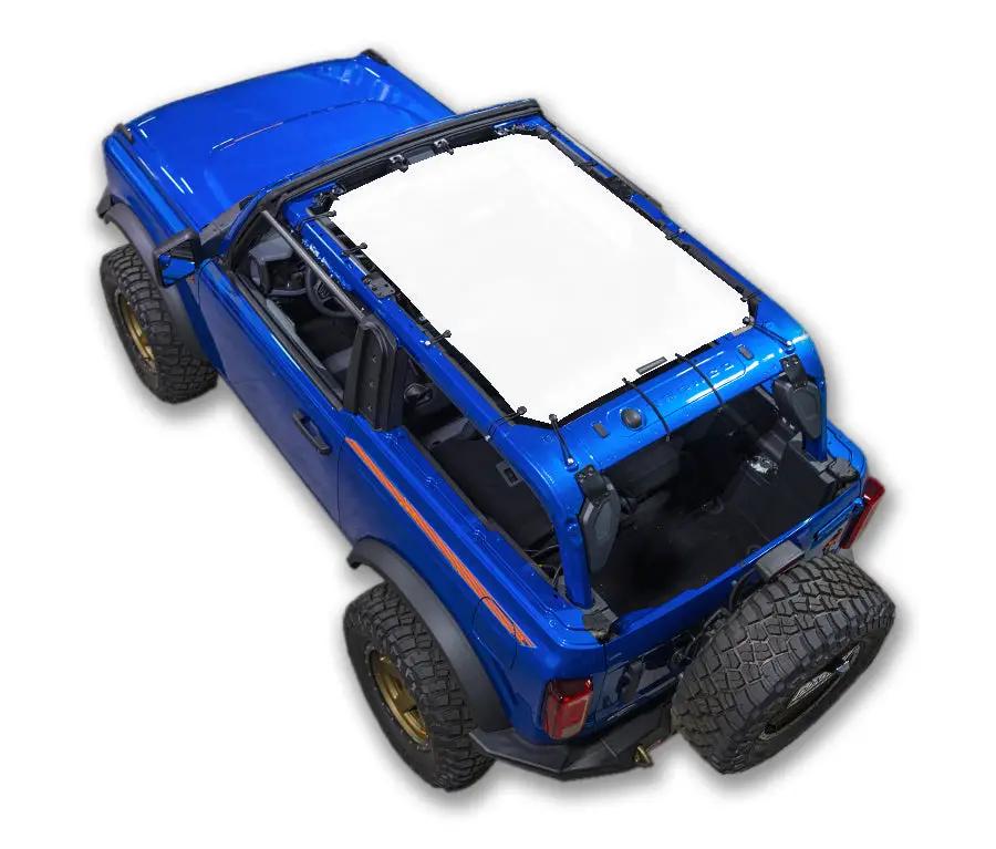 Ford Bronco sun shade top by SpiderWebShade; stock printed white shade panel on blue SUV