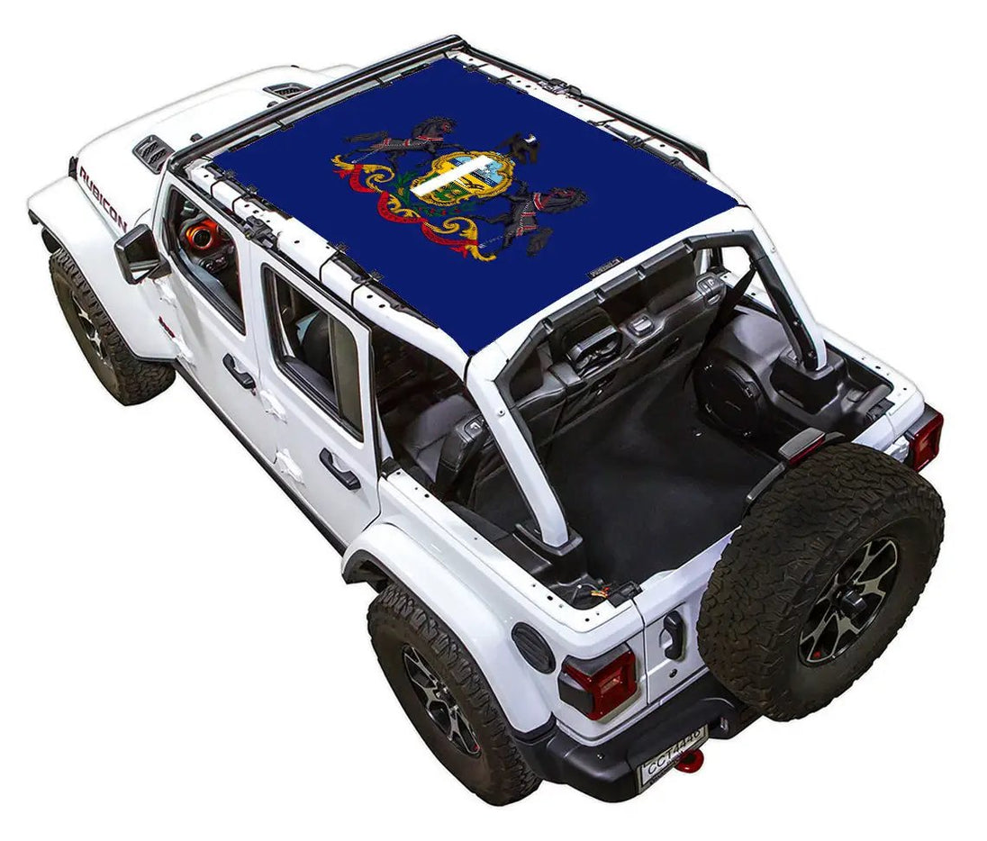 SpiderWebShade sun shade for Jeep Wrangler JLU 4-Door; blue stock printed top with crest design.