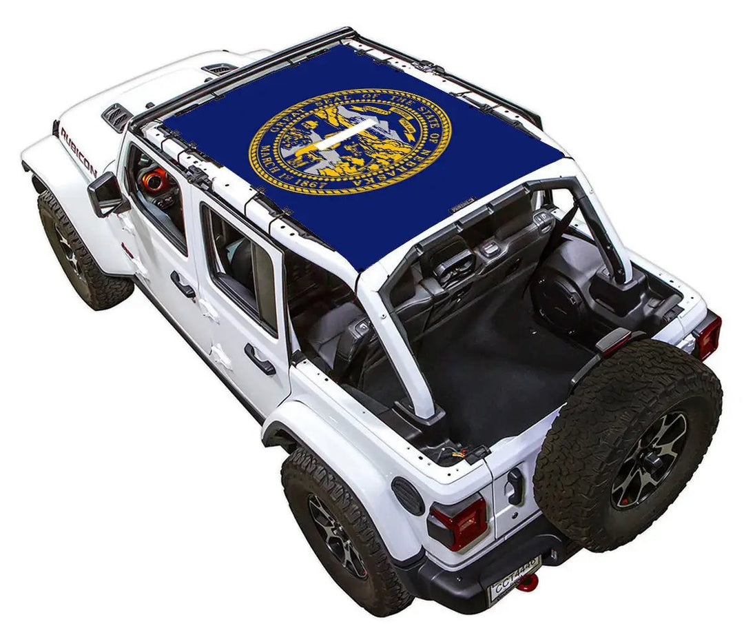 SpiderWebShade sun shade top for Jeep Wrangler JLU 4-Door; blue stock-printed shade with gold state seal logo.