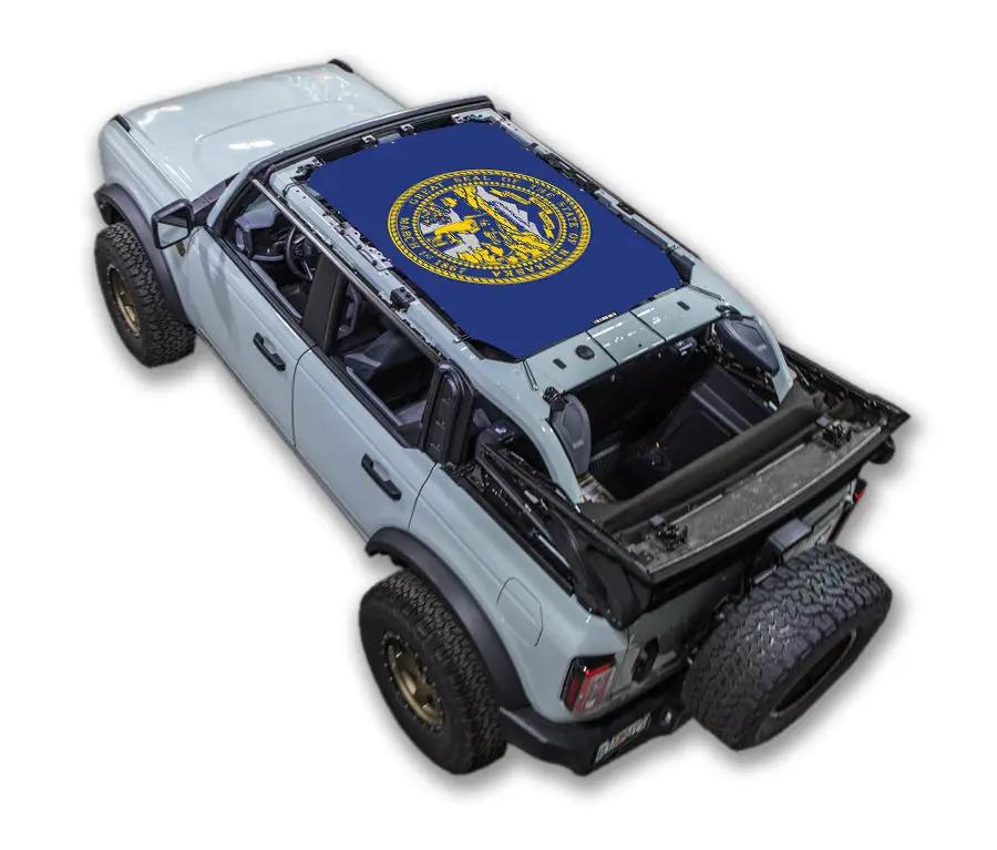 Sun shade SPIDERWEBSHADE for Ford Bronco (2021–2026), stock printed blue top with yellow circular emblem.