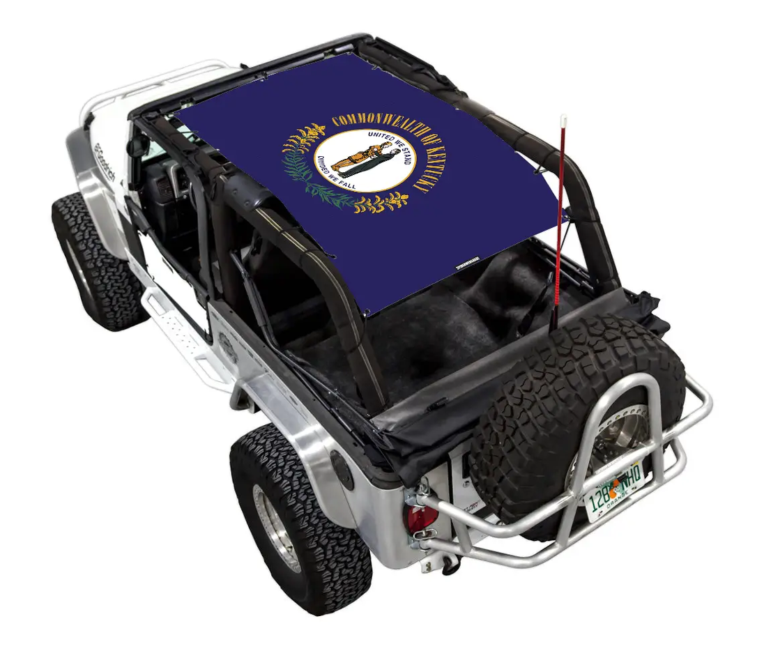 Sun Shade for Jeep Wrangler LJ 2004–2006 by SpiderWebShade; blue stock printed shade top with circular emblem.