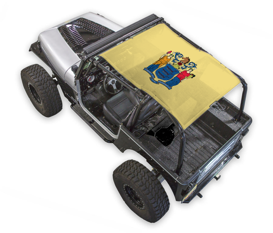 SPIDERWEBSHADE sun shade for Jeep Wrangler YJ (1987–1996), stock yellow printed top with coat-of-arms design.