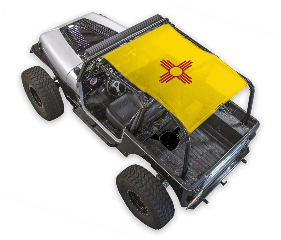 Jeep Wrangler YJ sun shade by SpiderWebShade; yellow stock printed shade top with red emblem.
