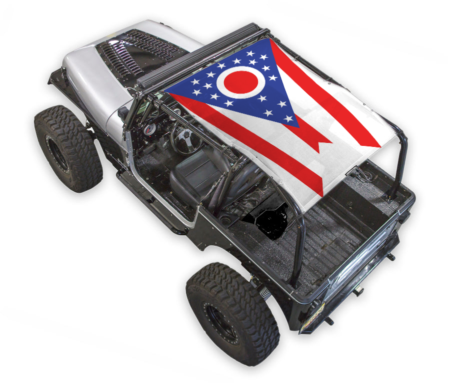 SpiderWebShade sun shade top for Jeep Wrangler YJ; stock printed shade with flag-style red, white, blue design.