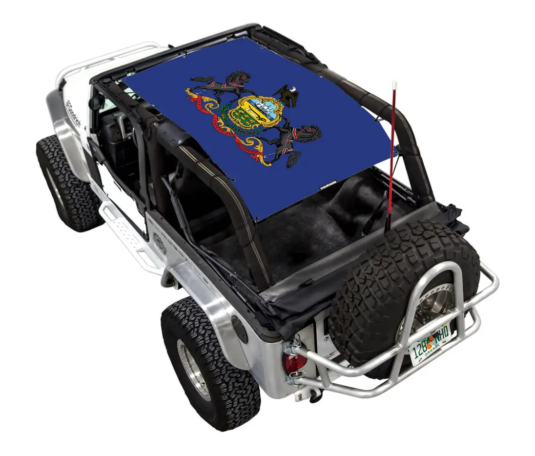 Sun shade top SpiderWebShade for Jeep Wrangler LJ 2004–2006, blue stock-printed design with crest motif.