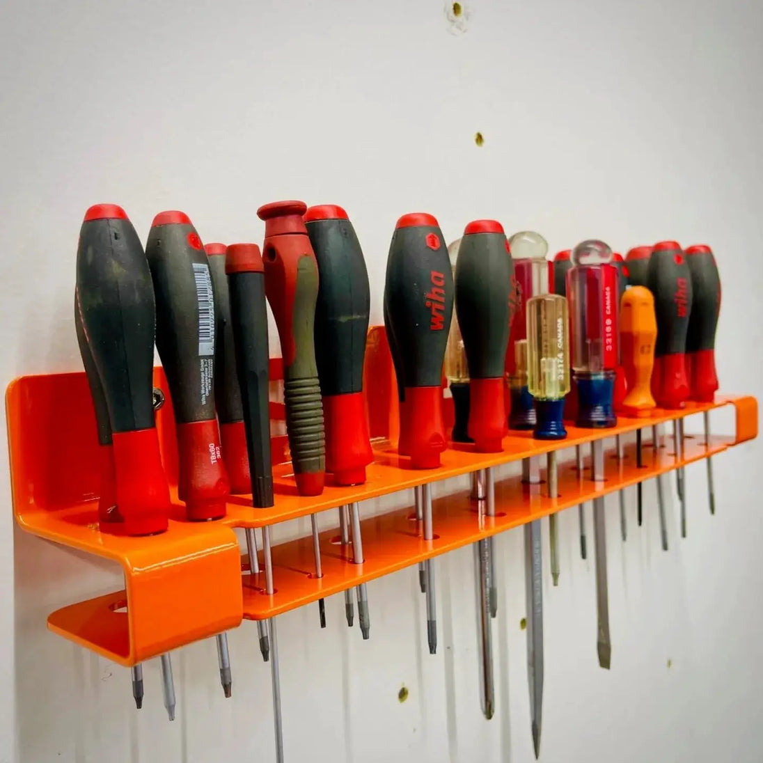 TMR Screwdriver Organizer Rack orange wall-mounted tool holder with row of red/black screwdrivers