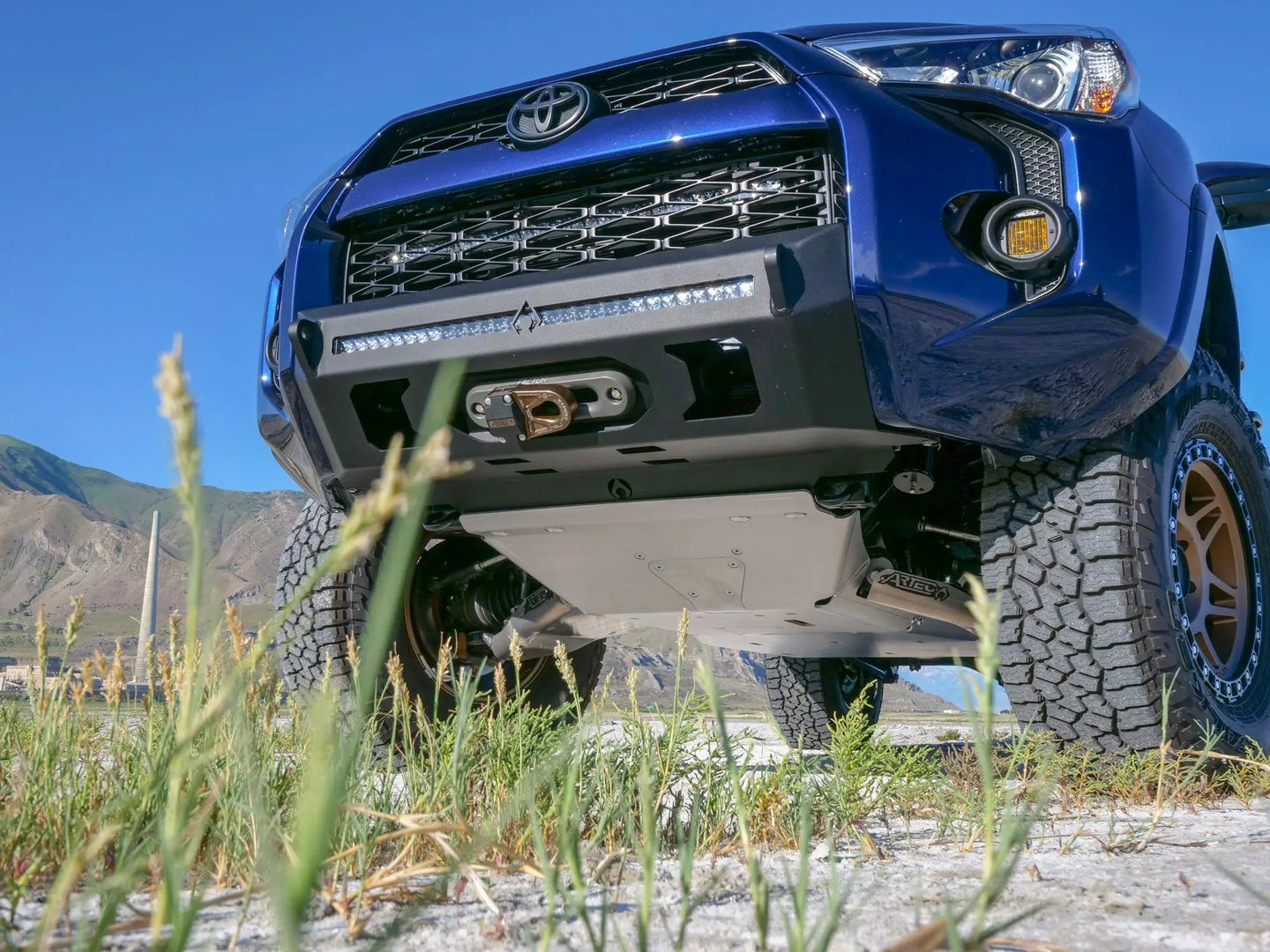 Artec 4Runner 5th Gen full skid plate system—A-arm, bellypan, fuel skid, undercarriage view on blue Toyota 4Runner