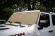 Solar shade for Jeep Wrangler and Gladiator by SpiderWebShade; tan shade on white vehicle