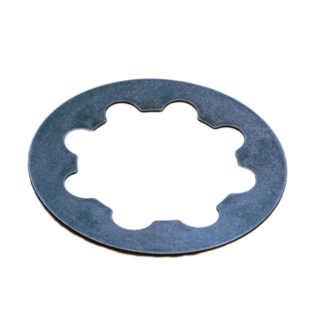 Power Driven Early Belleville Spring, clutch/transmission part; blue-gray steel ring with scalloped inner opening.