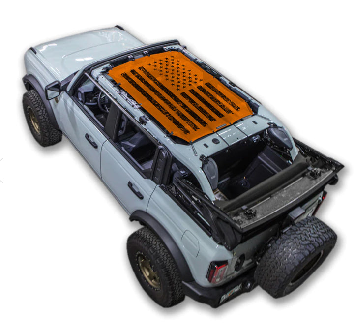 Ford Bronco sun shade by SPIDERWEBSHADE, orange printed shade top with star/stripe design - 2021-2026.