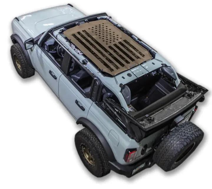 Ford Bronco sun shade by SpiderWebShade; stock printed beige shade top with flag design.