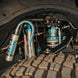 Dirt King Long Travel Kit for Toyota; blue anodized coilover shocks with hoses and fittings in wheel well