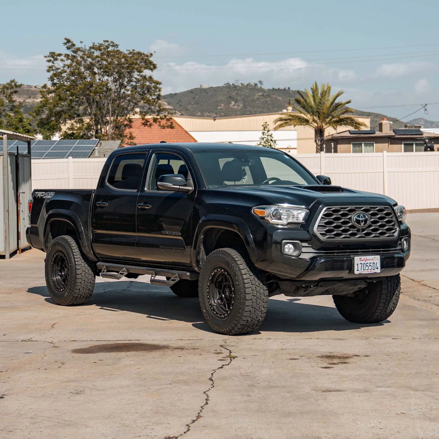 Dirt King 2.5 Coilovers DCA Remote Reservoir Toyota Tacoma in driveway, front-quarter view